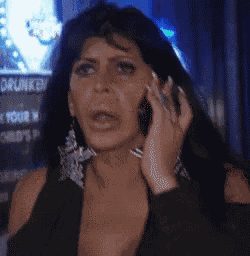 a woman is talking on a cell phone in front of a sign that says drunk on it .