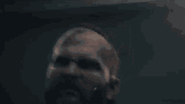 a close up of a man screaming with his mouth open in a video game .