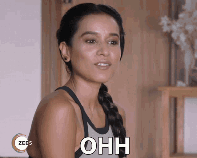 a woman with a braided hair and a sign that says ohh