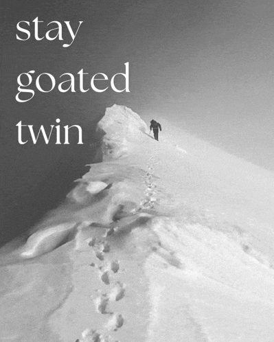 a black and white photo of a person walking up a snow covered mountain