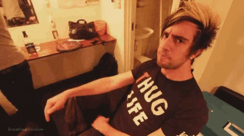 a man is wearing a black shirt that says hug life
