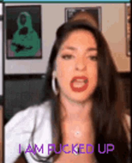 a woman is making a funny face with the words `` i am fucked up '' written on the bottom .