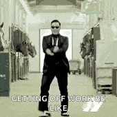 a man in a suit and tie is dancing in a stable with horses .