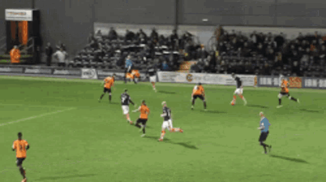 a blurry picture of a soccer game with an ad for toshiba