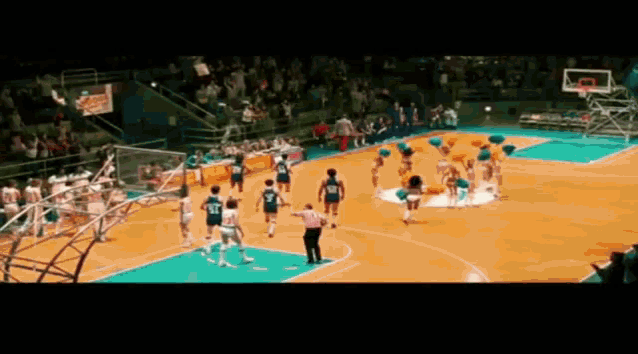 a basketball game is being played on a court with cheerleaders and a sign that says coca cola