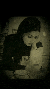 a black and white photo of a woman wearing a sweater that says " pacho "