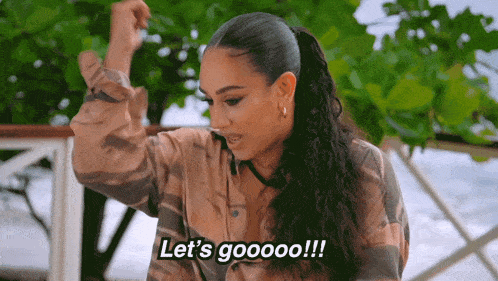 a woman in a plaid shirt says let 's gooooo !!