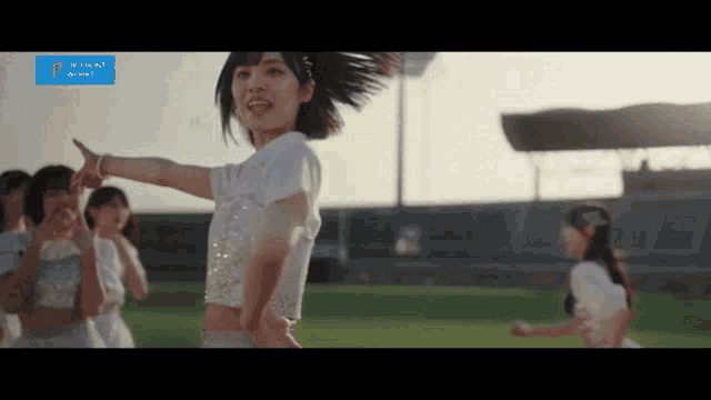 a group of girls are dancing in front of a sign that says up front