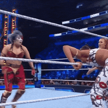 two women are wrestling in a ring with the word down on the ropes