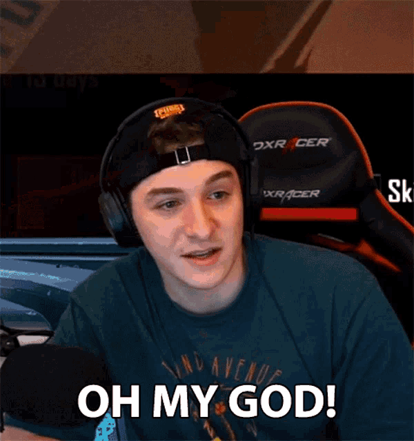a man wearing headphones and a hat is saying oh my god .