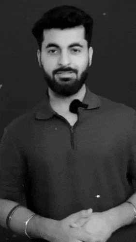 a man with a beard is making a funny face in a black and white photo with his eyes closed .