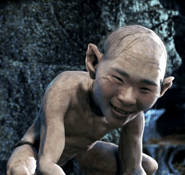 a cartoon character with a bald head and ears is smiling