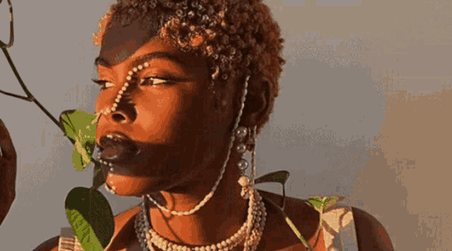 a woman wearing pearls and a nose ring