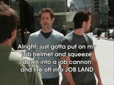 two men are walking down a street and one of them says alright just gotta put on my job helmet and squeeze