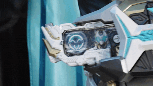 a close up of a white and blue robot with a smiley face on it