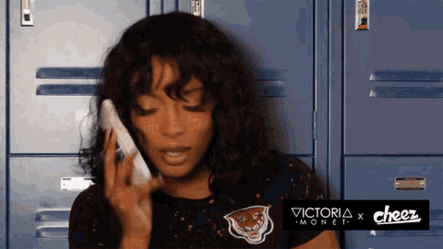 a woman is talking on a phone with a cheez logo in the corner