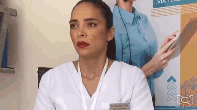 a woman wearing a name tag that says gloria mayaca on it