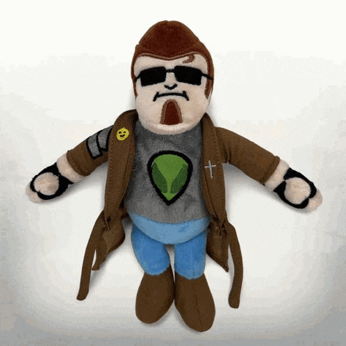 a stuffed toy of a man with a cross on his jacket