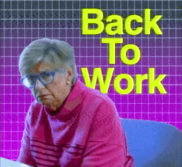 an elderly woman wearing glasses is sitting at a desk in front of a sign that says `` back to work '' .