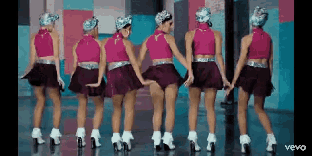 a group of women are dancing together in a video .