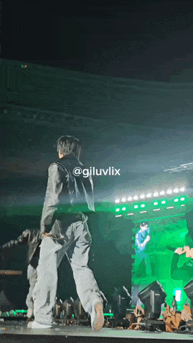 a person standing on a stage with the name giluvlix written on the bottom