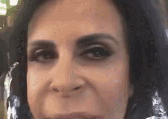 a close up of a woman 's face with a slight smile on it .