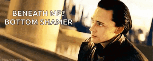 a man in a suit and tie is standing next to a sign that says beneath me bottom shamer .