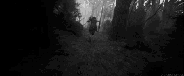 a black and white photo of a person running through a forest .