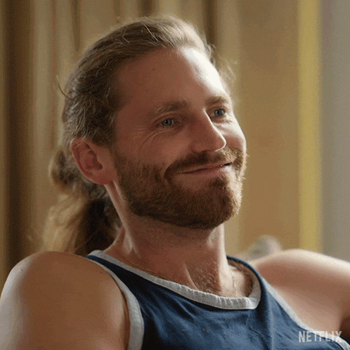 a man with a ponytail and a beard is wearing a netflix shirt
