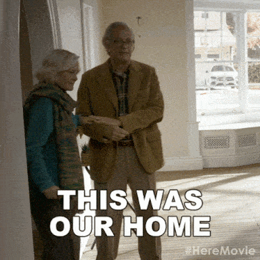 a man and a woman are standing in a room with the words this was our home