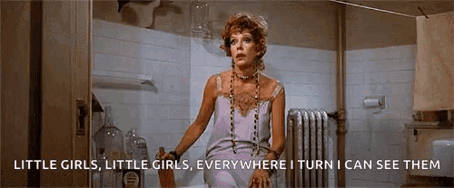 a woman is standing in a bathroom with the words little girls little girls everywhere i turn i can see them on the bottom