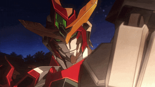 a close up of a robot with green eyes and a red and yellow helmet