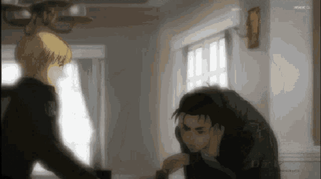 a couple of men are standing next to each other in a room .