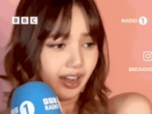 a woman is talking into a microphone that says bbc radio 1 on it