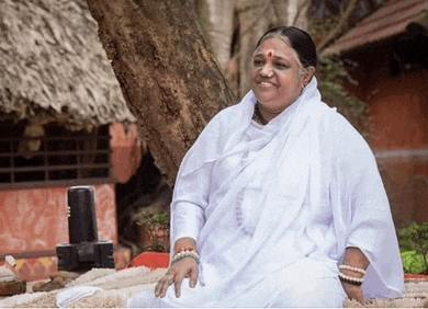 a woman in a white dress is sitting under a tree and smiling