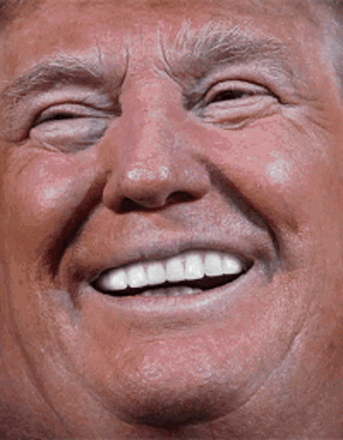 a close up of a man 's face with a smile on his face