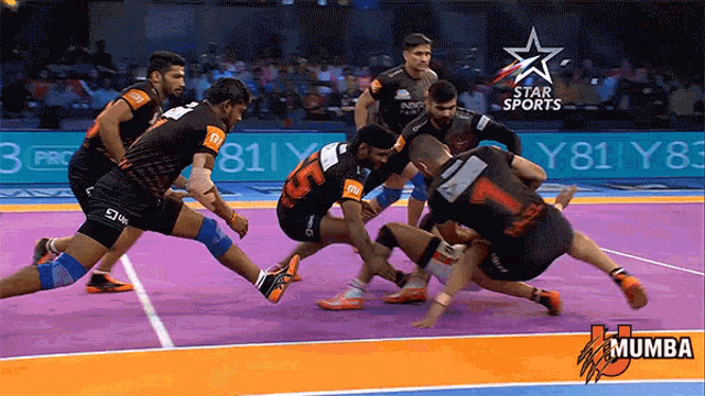 a group of men are playing a game of kabaddi on a court with a star sports logo behind them