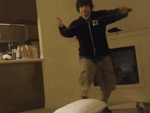 a man playing a video game in a living room