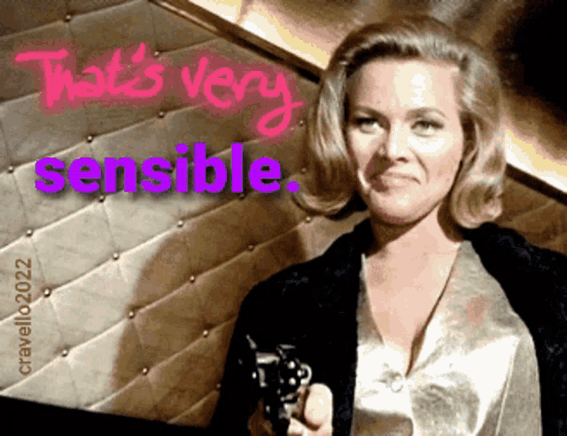 a woman holding a gun in front of a wall that says that 's very sensitive