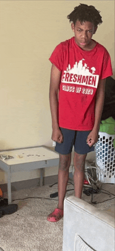 a young man wearing a red shirt that says freshmen