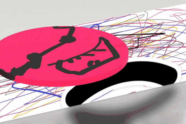 a pink circle with a drawing of a saxophone on it is on a white surface