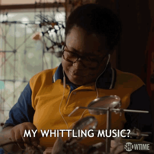a person wearing headphones and a yellow shirt says my whittling music
