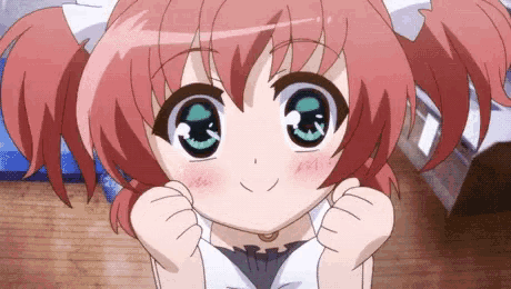 a girl with red hair and blue eyes is making a face