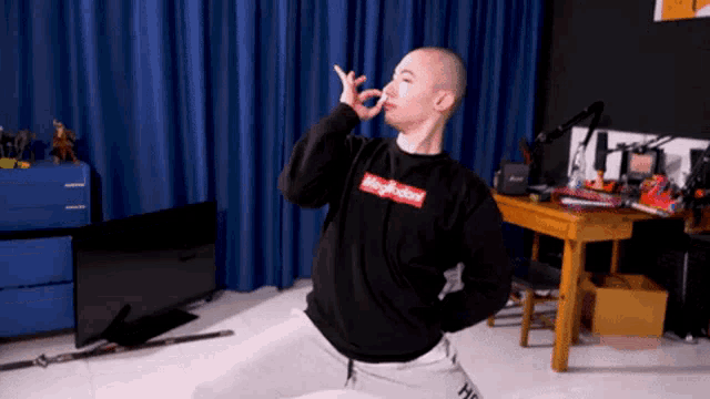 a man wearing a black sweatshirt that says magruder on it