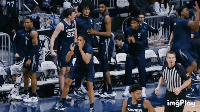 a group of basketball players wearing blue uniforms with xavier on the front