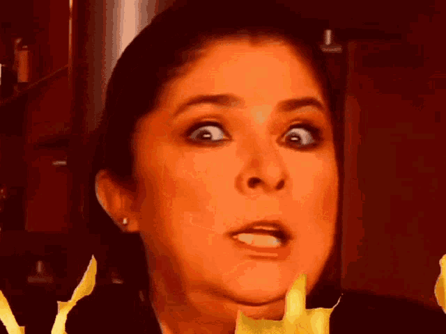 a close up of a woman 's face with flames coming out of her mouth