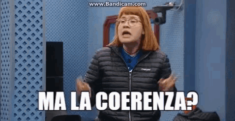 a woman wearing glasses and a black jacket says " ma la coerenza "