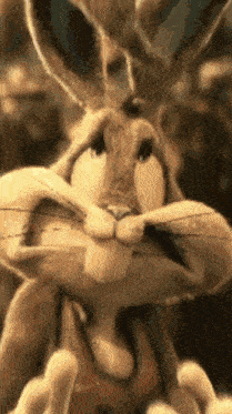 bugs bunny from looney tunes is making a funny face with his mouth wide open .