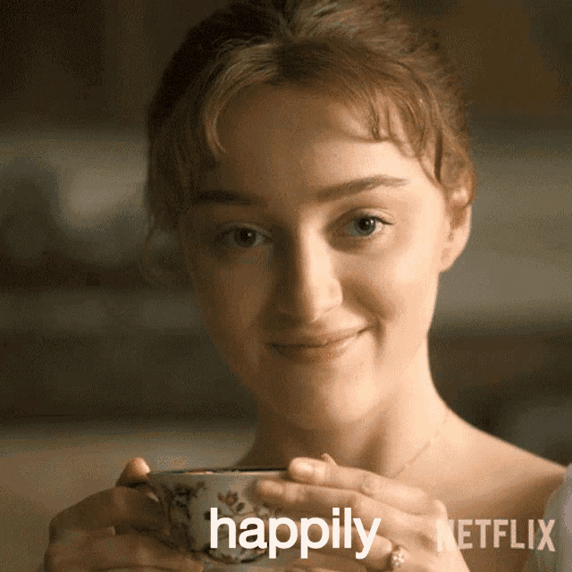 a woman is smiling while holding a cup with the word happily written on it