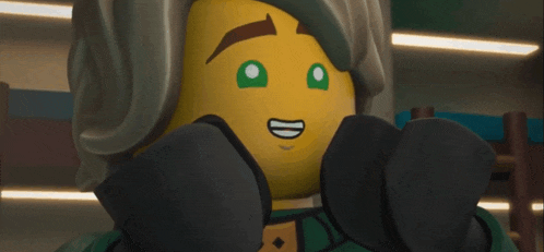 a close up of a lego character with green eyes and a smile on his face .